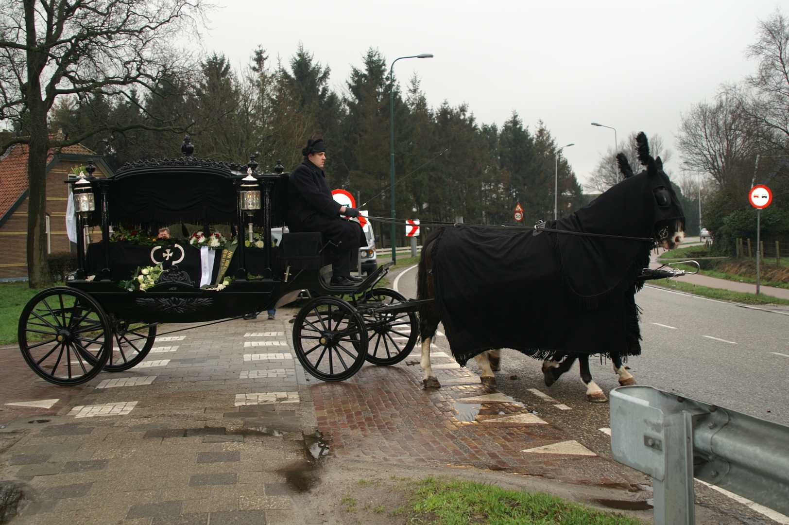 Zwarte rouwkoets met 2 span Gelderse paarden tijdens de uitvaart van Martin Bakker in Hoevelaken